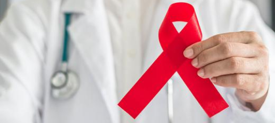 A clinical professional holding the red ribbon.