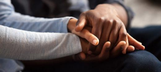 Two people holding their hands.